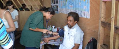 A volunteer doing a routine checkup on a man at her placement in Ghana A Projects Abroad volunteer doing a basic checkup on man at her Spring Break Public Health placement in Ghana